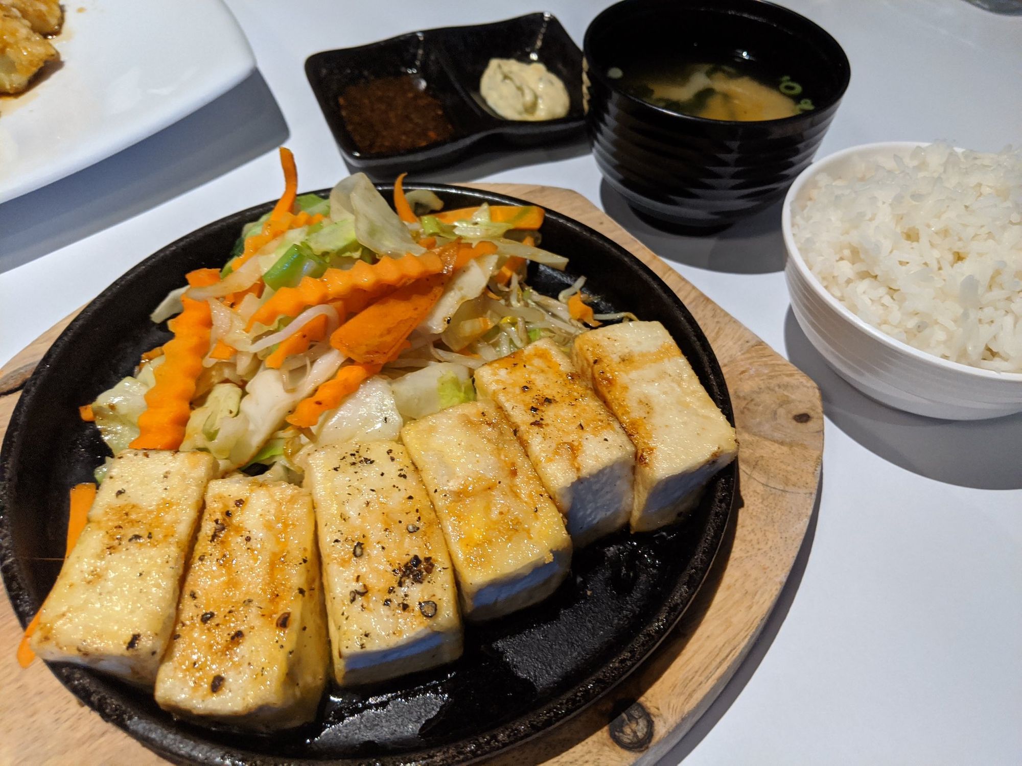Tofu, veges on hotplate, with side of rice.